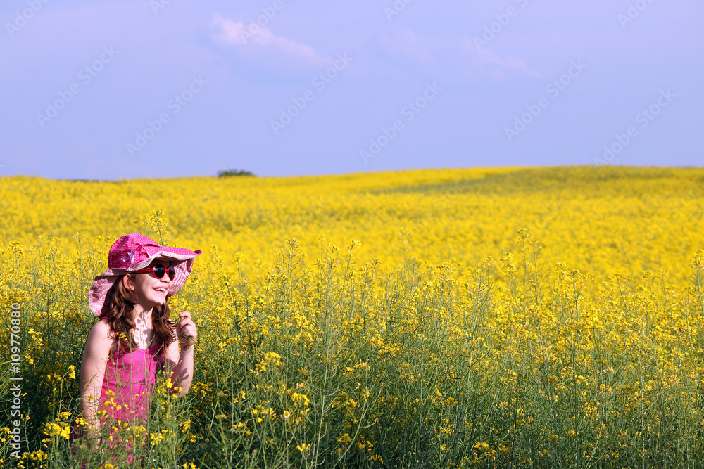 Happy little girl on field summer season