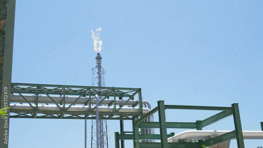 Fire from flare structure in petroleum and chemical plant with blue sky Fire from flare structure in petroleum and chemical plant with blue sky