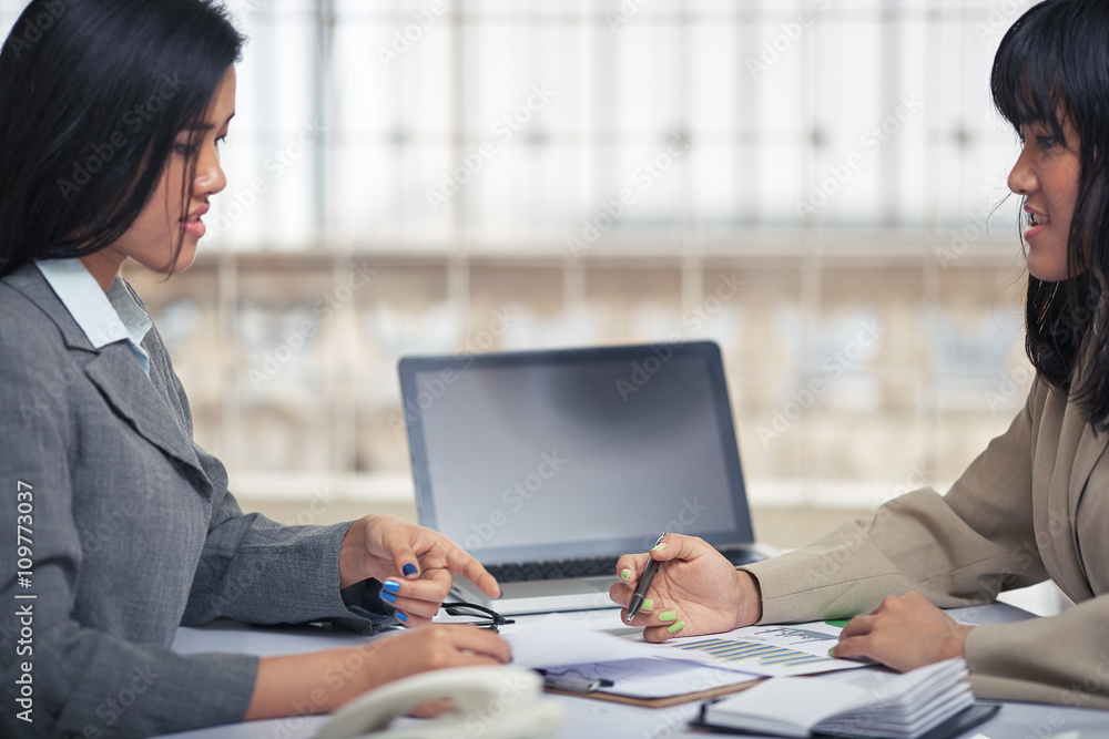side view of friendly businesswomen discussing and consulting document
side view of friendly businesswomen discussing and consulting document