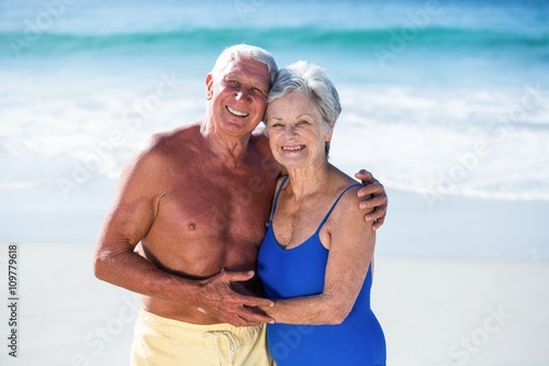 Cute mature couple hugging on the beach