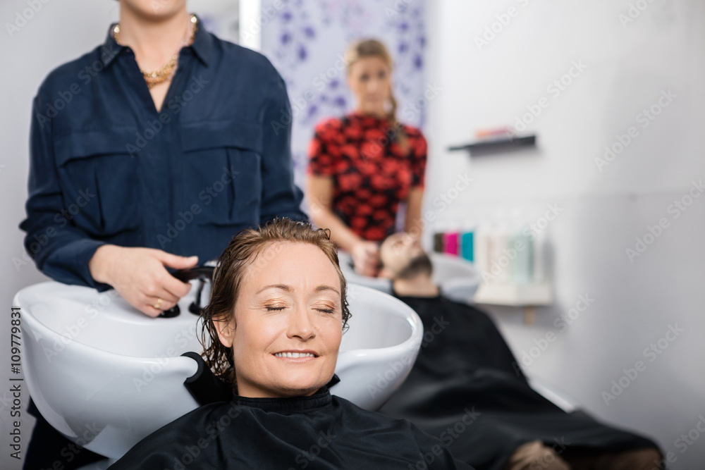 Relaxed Woman Getting Hair Washed In Salon Relaxed Woman Getting Hair Washed In Salon