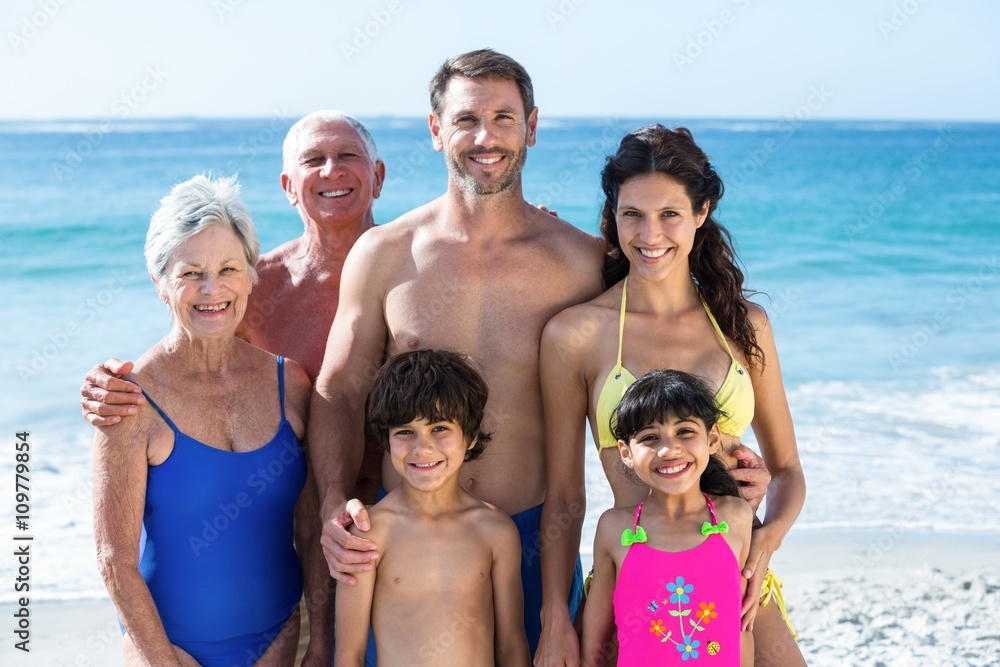 Cute multi generation family posing on the beach Cute multi generation family posing on the beach