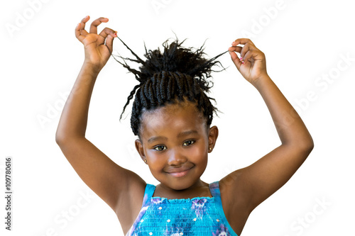 Cute african girl playing with braided hair.