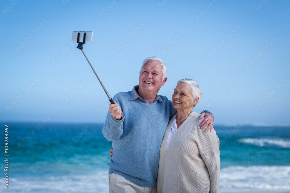 Cute mature couple taking selfie with selfie stick Cute mature couple taking selfie with selfie stick