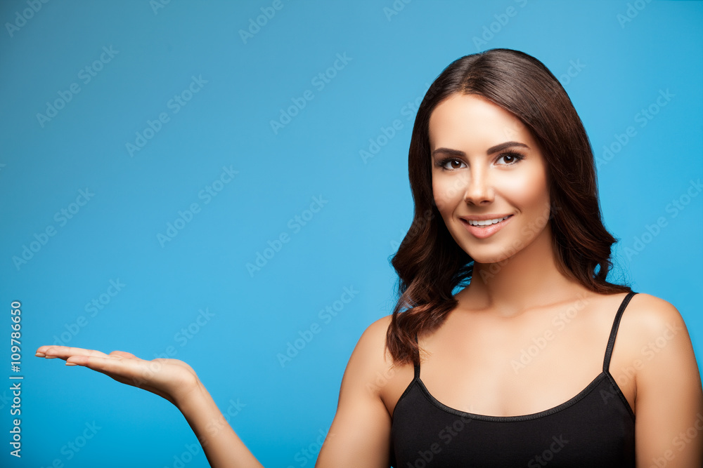 woman showing copyspace or something, on blue woman showing copyspace or something, on blue