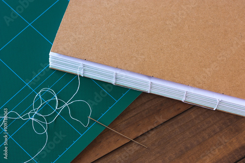 Handbound book with needle and thread photo