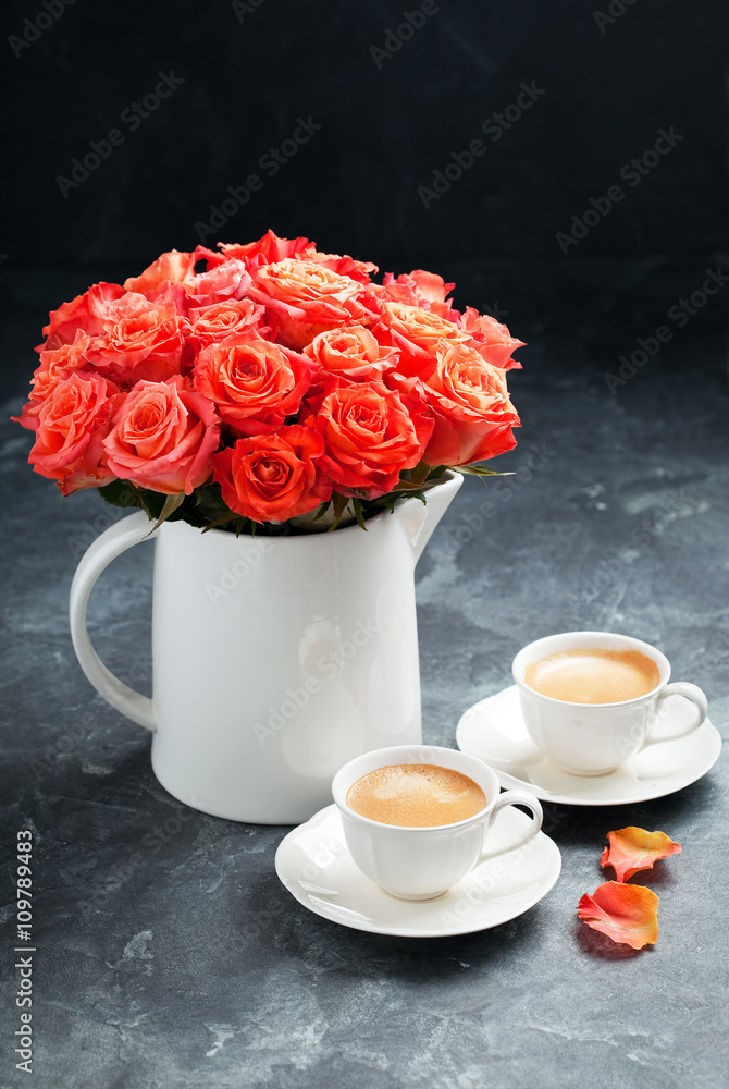 Two cups of espresso and a bouquet of roses, selective focus Two cups of espresso and a bouquet of roses, selective focus