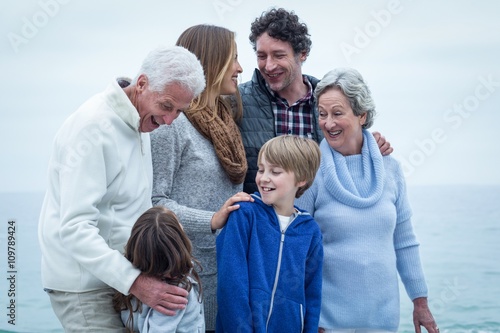 Family standing at beach © WavebreakmediaMicro