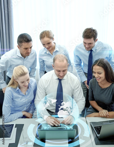 smiling business people with laptop in office