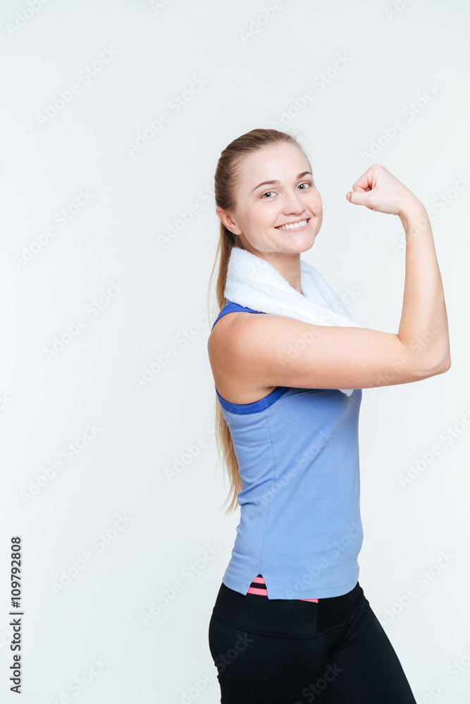 Smiling fitness woman showing her biceps Smiling fitness woman showing her biceps