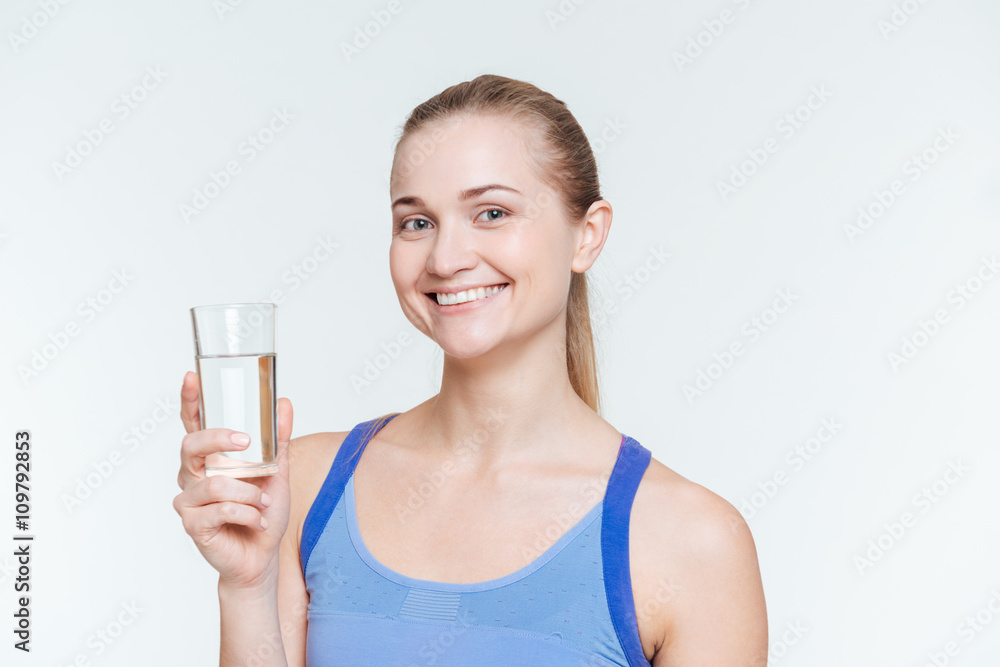 Smiling fitness woman holding glass with water Smiling fitness woman holding glass with water