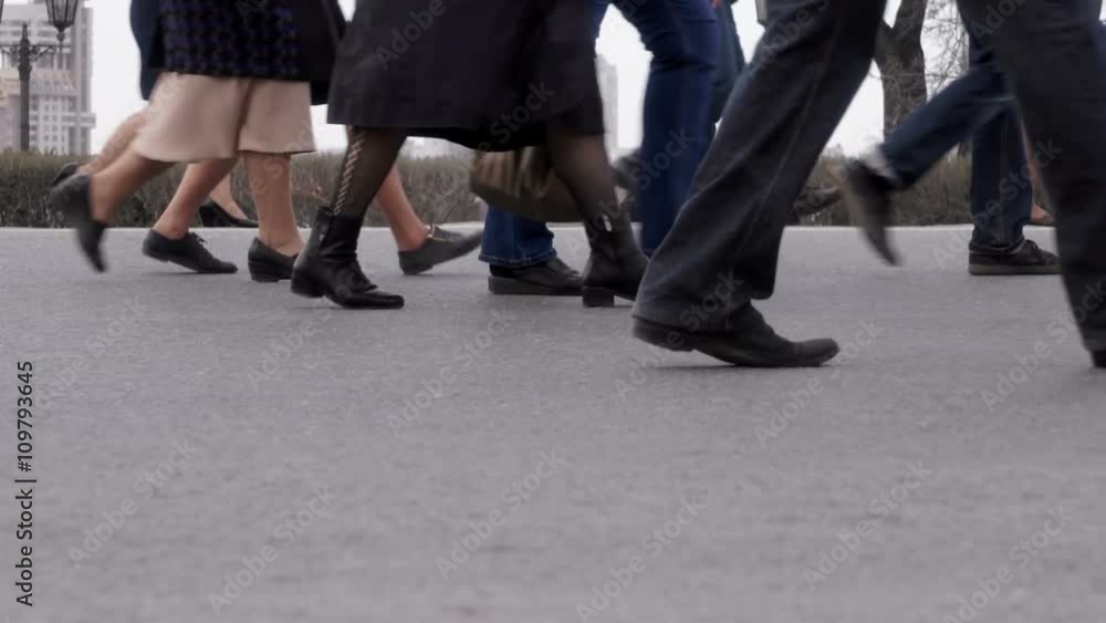 a crowd of people walking down the street a crowd of people walking down the street