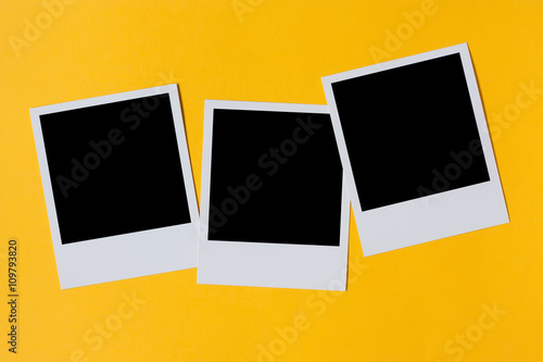 Polaroid photo prints isolated on yellow