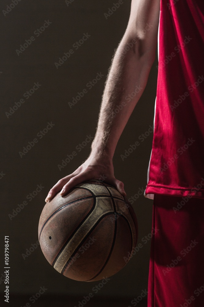 Fototapeta premium Close up on basketball held by basketball player