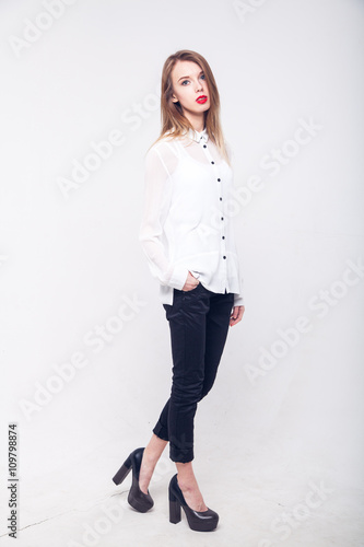 Contemporary Clothing Design. Modish Woman in White Blouse and Pants. Fashion