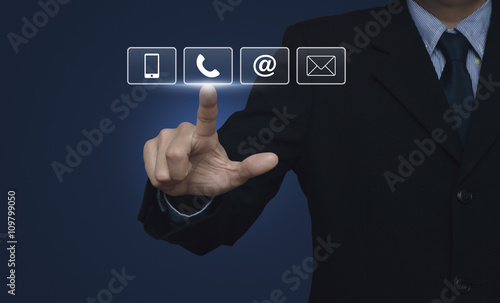 Businessman pressing telephone, mobile phone, at and email butto