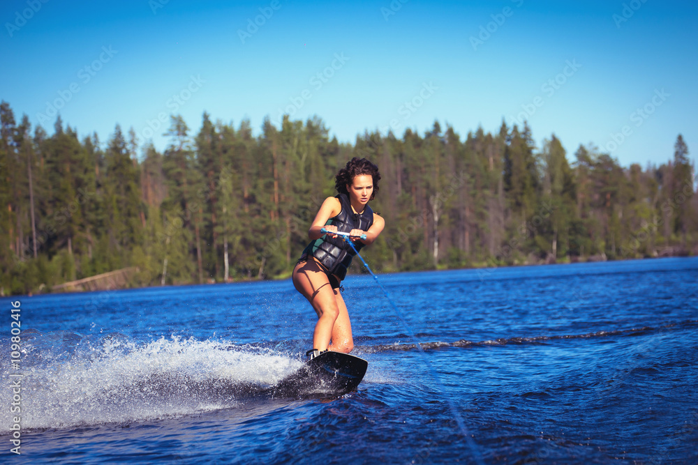 Woman study wakeboarding on a lake