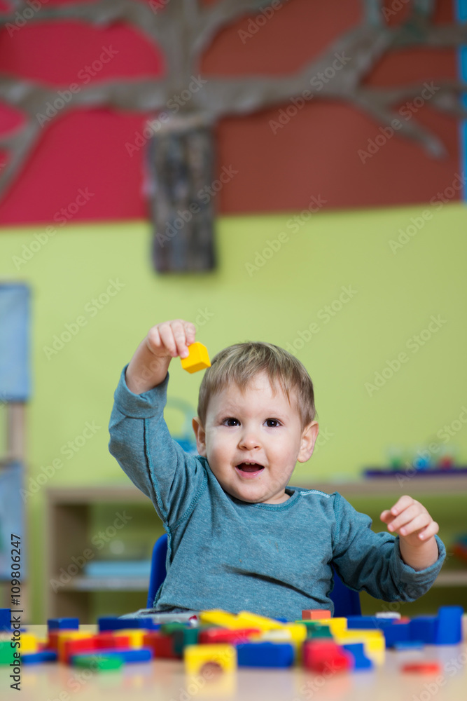 Little caucasian boy playing with Montessori toy in pre-school Little caucasian boy playing with Montessori toy in pre-school