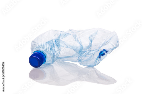 Mineral water bottles crushed and crumpled against white background