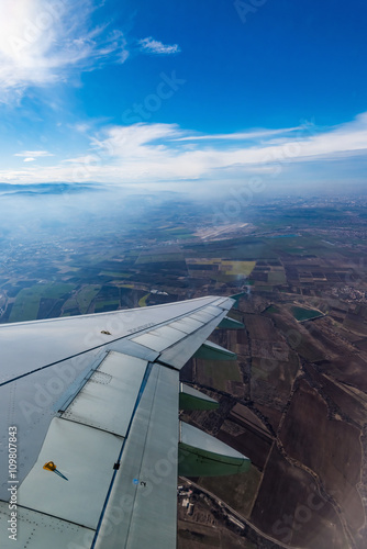 view of the wing of an airplane through the window © dbrus