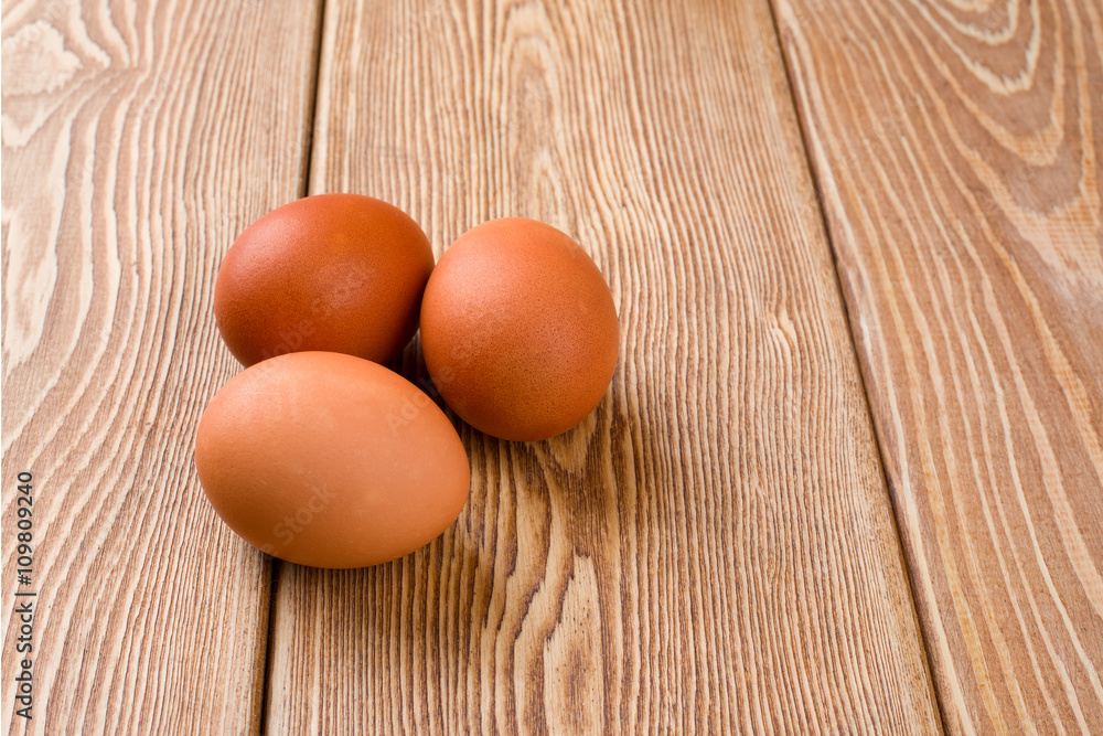 Three eggs on a wooden background Three eggs on a wooden background