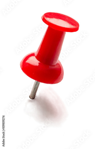 Red pin or thumbtack isolated on white background.