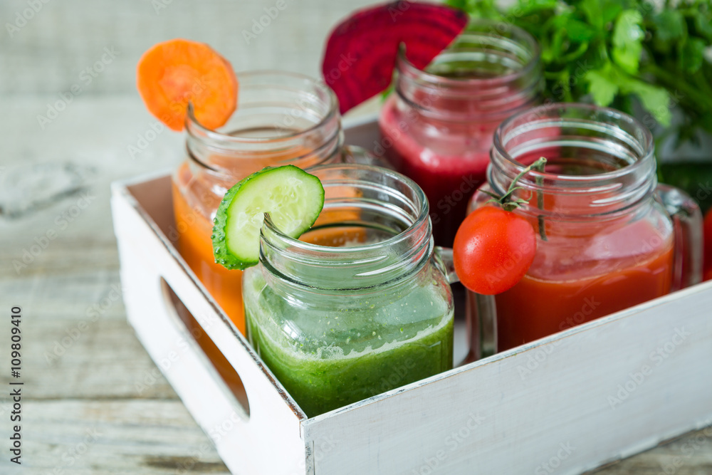 Selection of colorful vegetable juices in glass jars Selection of colorful vegetable juices in glass jars