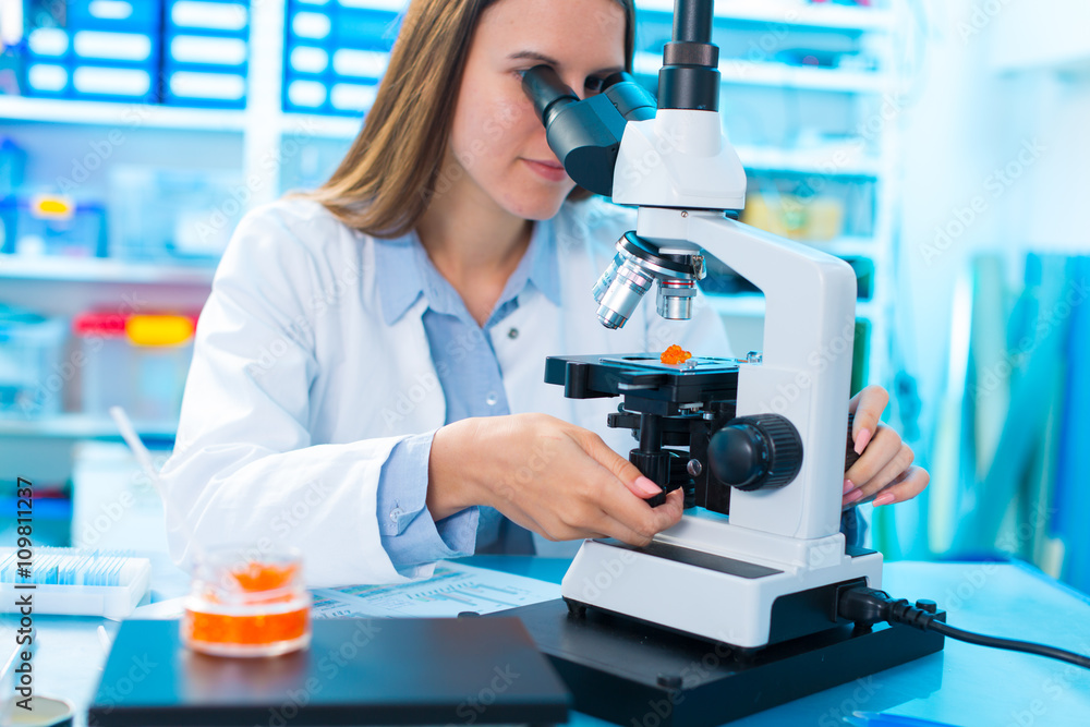 Quality control of food products. Young woman in chemical labora Quality control of food products. Young woman in chemical labora