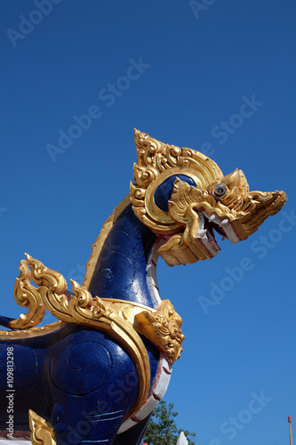 tiger statue against blue sky.