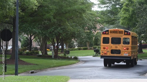 School bus driving thru a neighborhood