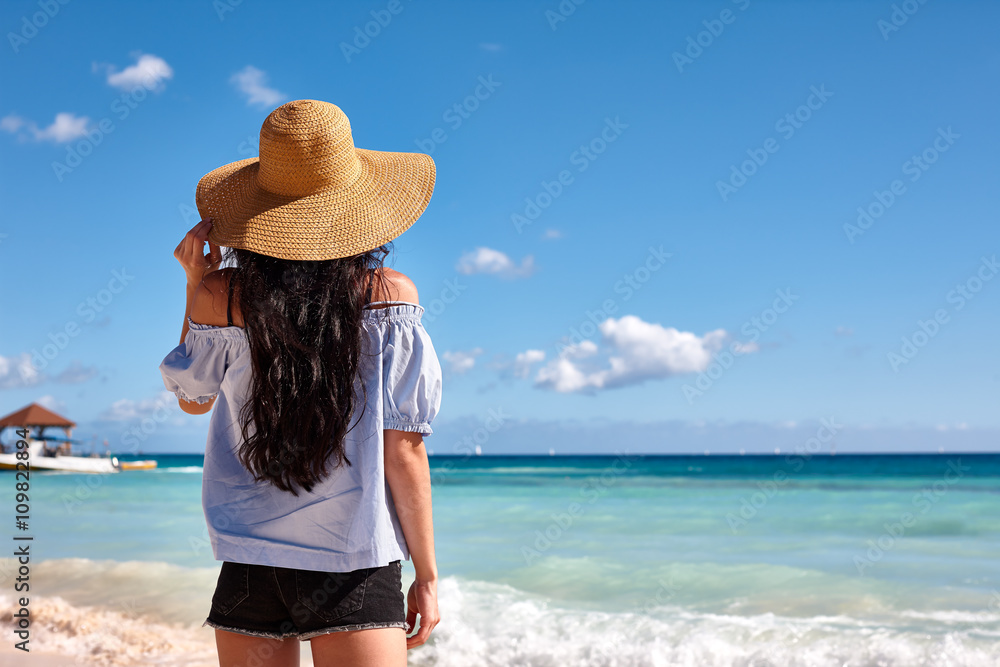 Woman in sunhat on a beach