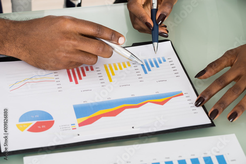 Graphs And Charts Analyzed By Businesspeople