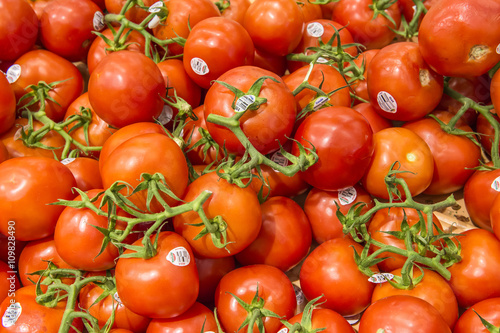 red tomato in market from market shelves real with flaws and bru