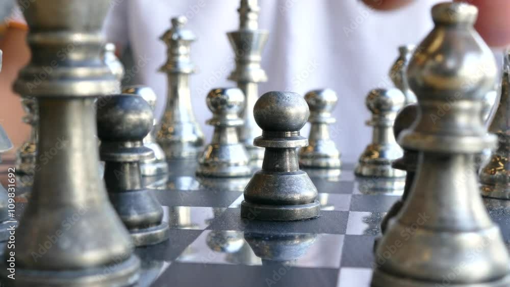 concept of Man playing silver chess concept of Man playing silver chess
