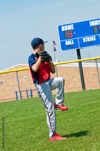 Youth baseball pitcher warming up before pitching.