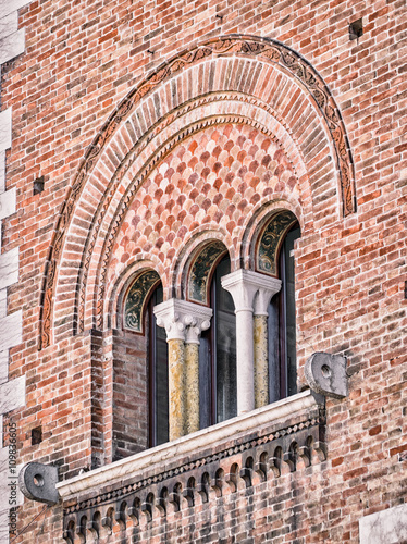 Triple lancet window of medieval palace. photo