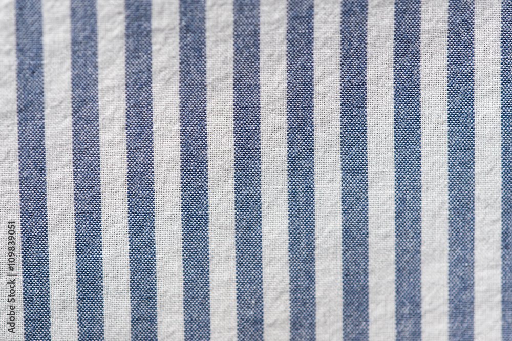 Textile background from a fabric with blue and white stripes Textile background from a fabric with blue and white stripes