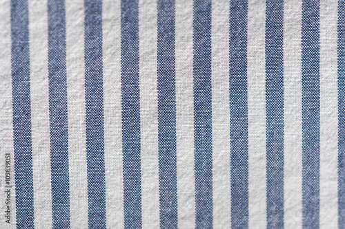 Textile background from a fabric with blue and white stripes