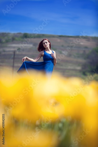Woman in yellow tulips field outside © DC Studio
