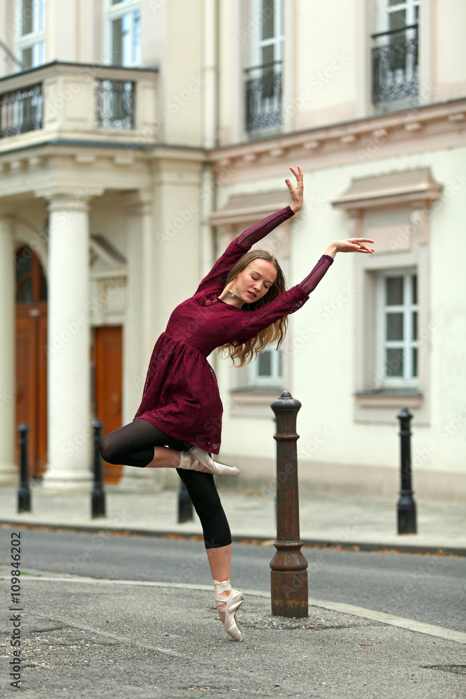 Beautiful ballerina dancing on the street