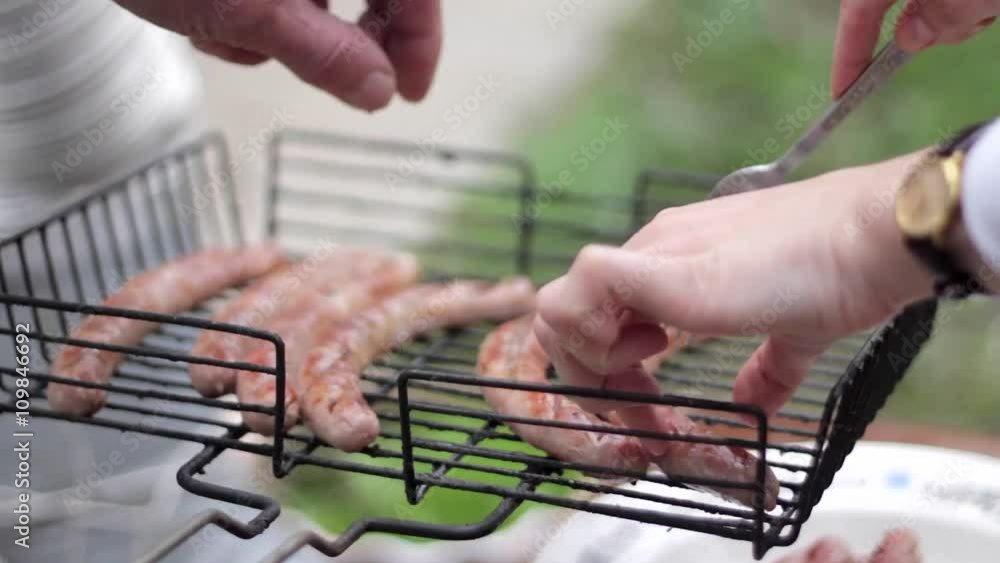 Bratwurst sausages cooking on a wood barbecue. Bratwurst sausages cooking on a wood barbecue.