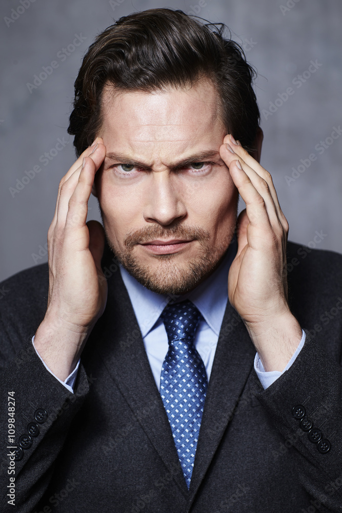 Businessman thinking hard in studio, portrait Businessman thinking hard in studio, portrait