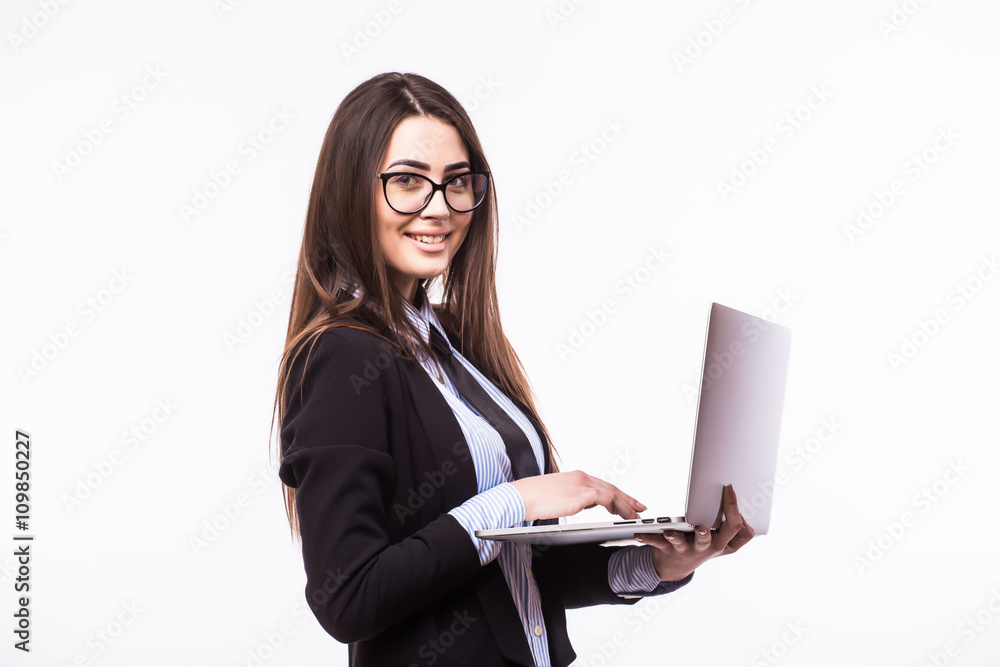 Happy businesswoman standing with laptop isolated on a white background. Looking at camera Happy businesswoman standing with laptop isolated on a white background. Looking at camera