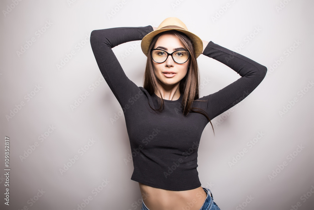 Portrait of beautiful young woman in glasses and funky hat over white background Portrait of beautiful young woman in glasses and funky hat over white background