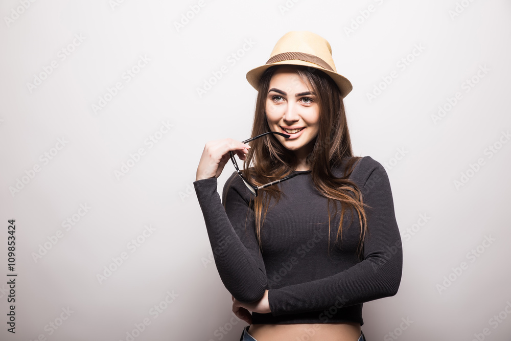 Portrait of beautiful young woman in glasses and funky hat over white background Portrait of beautiful young woman in glasses and funky hat over white background