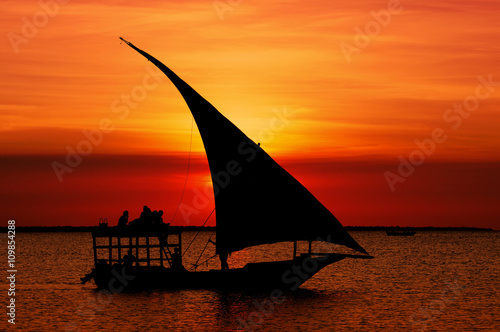 Fishermen Dhow Boat coming back home at sunset from a long day in the sea.