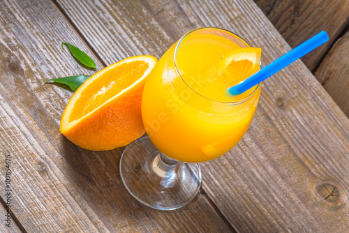 Fresh orange juice with ice  on wooden background