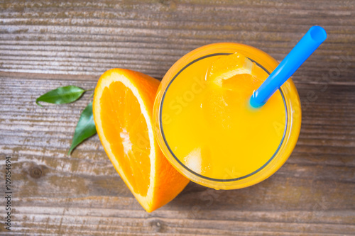 Fresh orange juice with ice  on wooden background