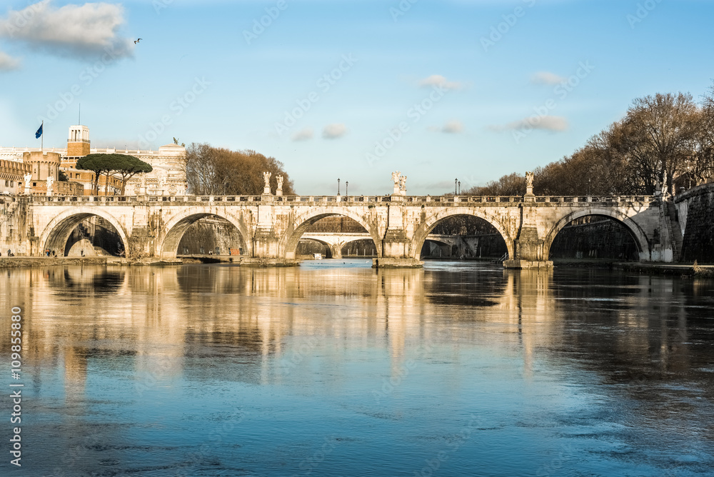 image of bridge Vittorio Emanuele reflection on the river Tiber.