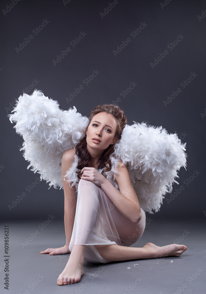 Studio shot of sad woman in guardian angel costume Studio shot of sad woman in guardian angel costume